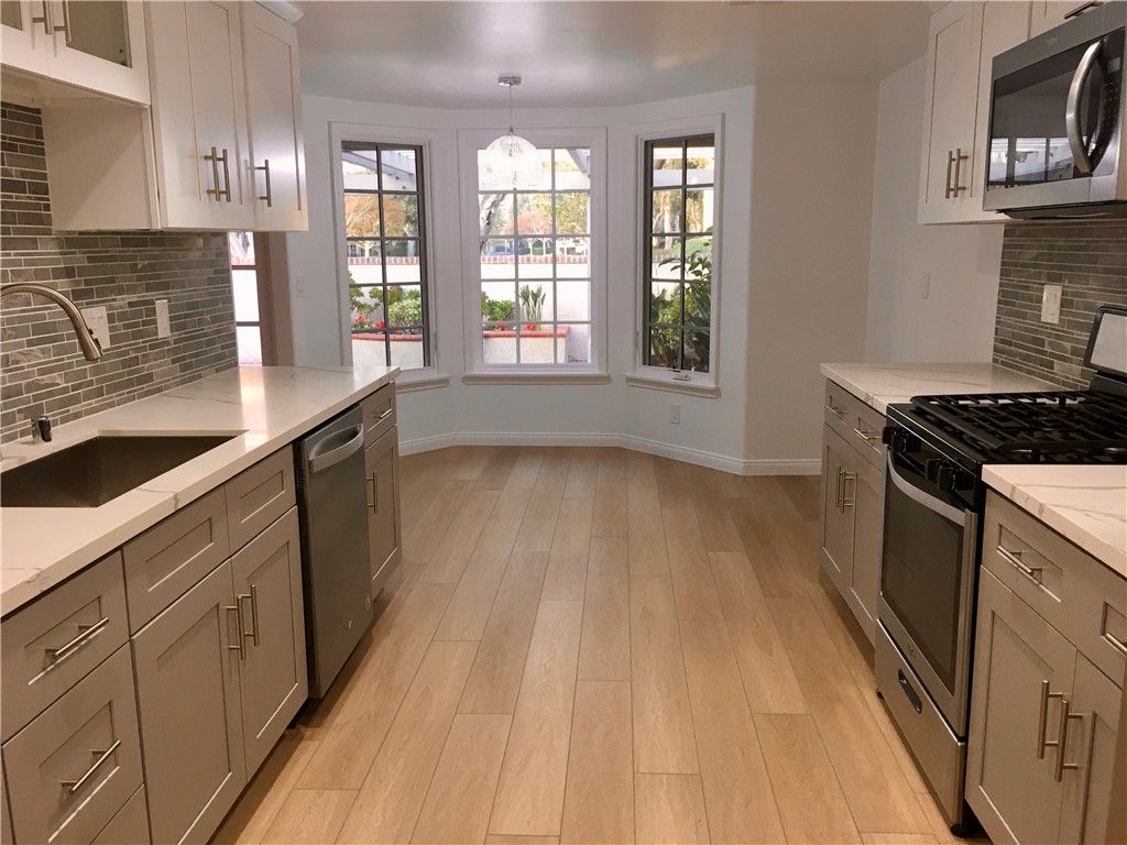 6 Dover Place Manhattan Beach, CA 90266 - Photo 2 of 25 a kitchen that has a sink and a stove