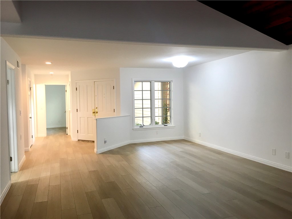 6 Dover Place Manhattan Beach, CA 90266 - Photo 4 of 25 an empty room with wooden floor and windows