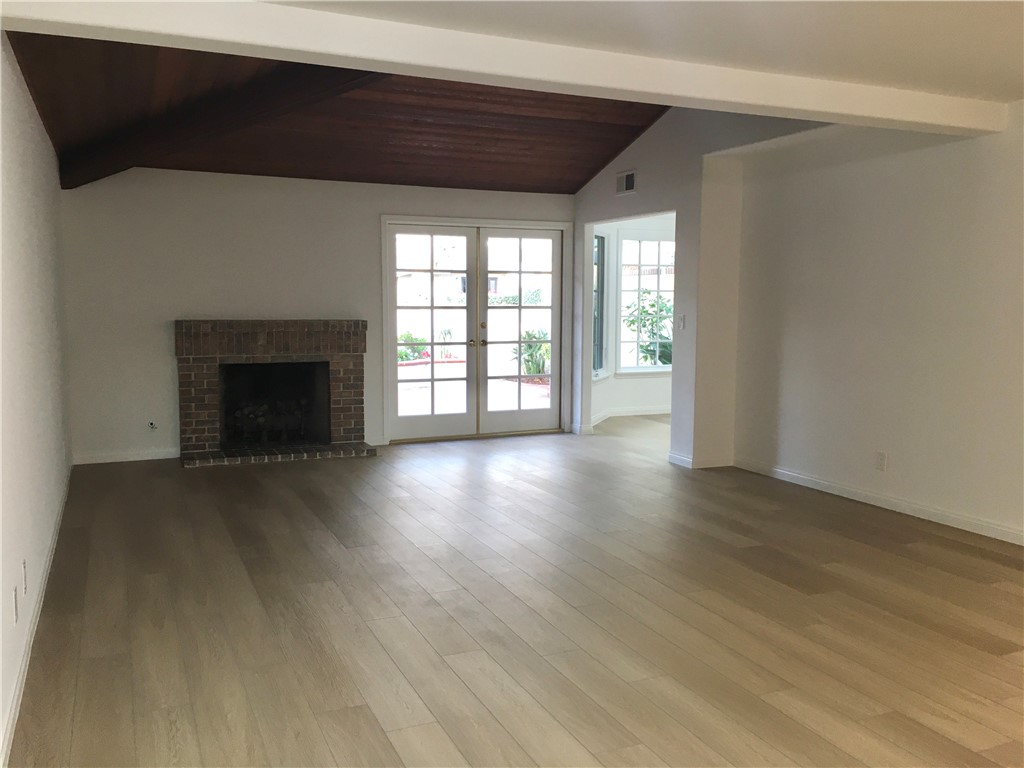 6 Dover Place Manhattan Beach, CA 90266 - Photo 5 of 25 an empty room with wooden floor fireplace and windows