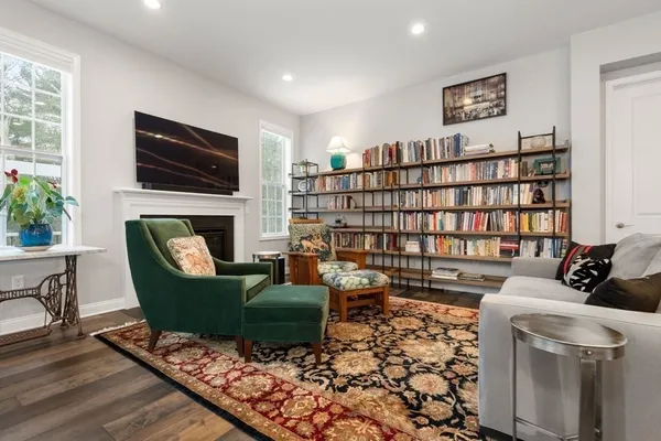 a kitchen with stainless steel appliances a dining table chairs stove and cabinets