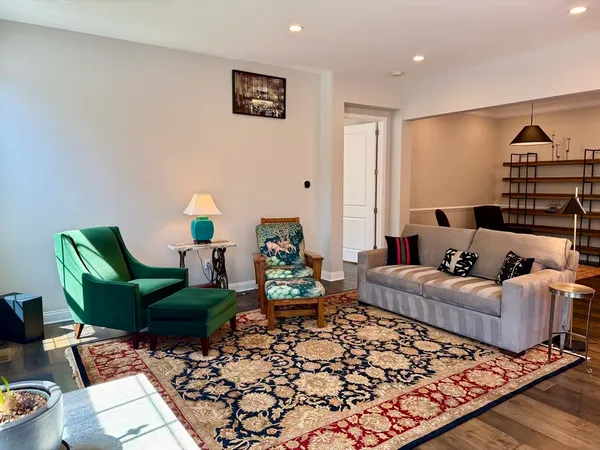 a dining room with furniture a chandelier and wooden floor