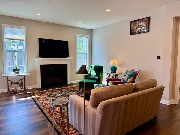 a large kitchen with stainless steel appliances kitchen island granite countertop a large island a stove and a wooden floors