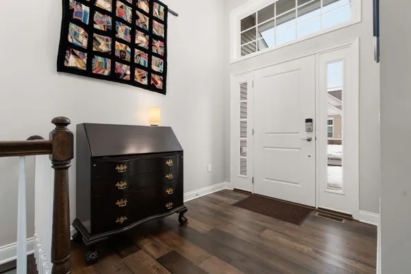 a kitchen with stainless steel appliances granite countertop a sink a stove and a wooden floors