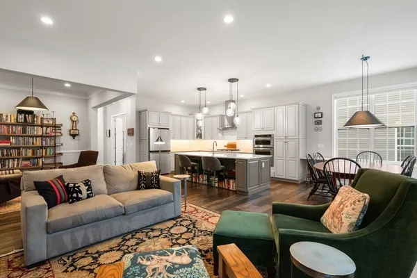 a living room with furniture a rug and a flat screen tv