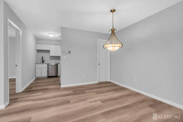 a view of a room with cabinet and wooden floor