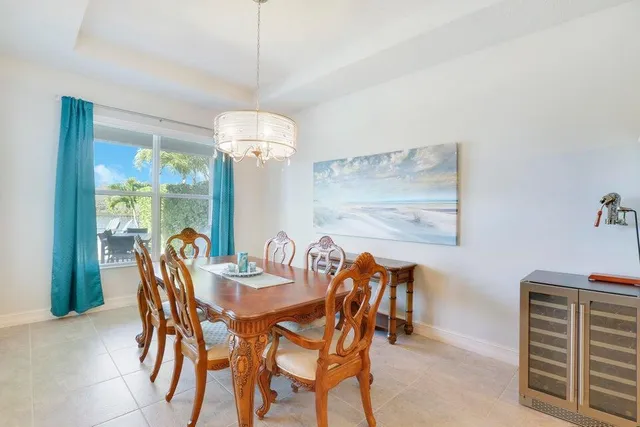 a dining room with furniture a chandelier and window