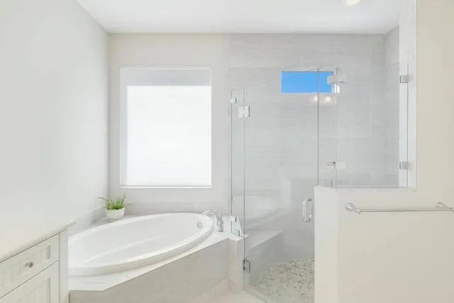 a white bath tub sitting next to a white sink