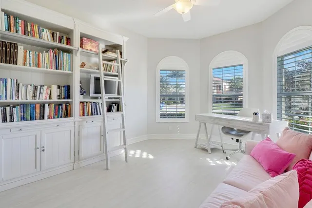 a living room with furniture and a book shelf