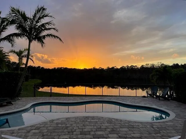 a view of a swimming pool with a table and chairs