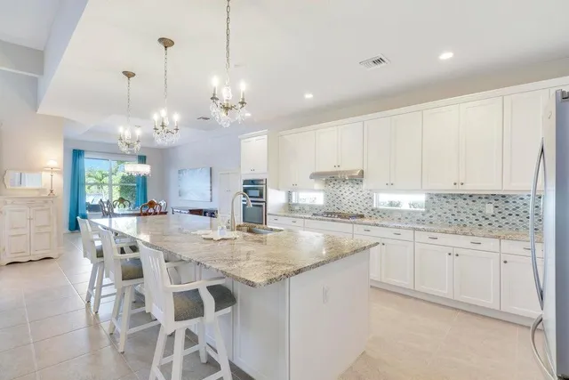 a kitchen with center island table and chairs in it
