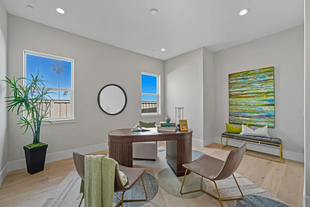 a living room with furniture a window and a potted plant