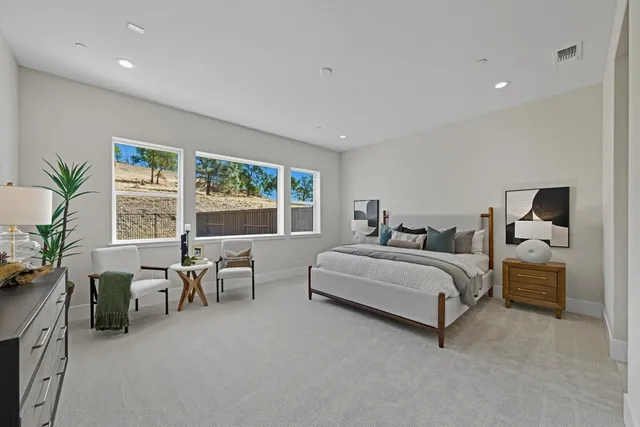 a bedroom with bed and a large window