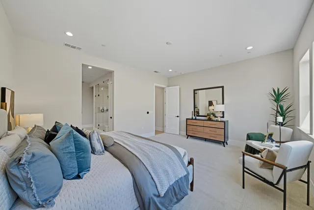 a bedroom with furniture and a potted plant