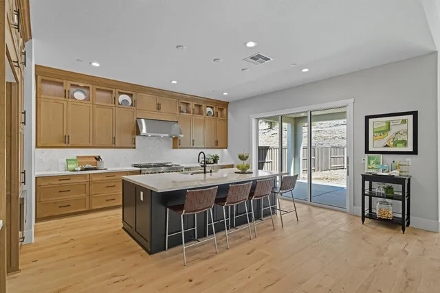 a kitchen with a stove and a refrigerator