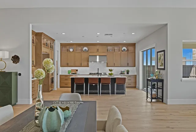 a large kitchen with a table and chairs