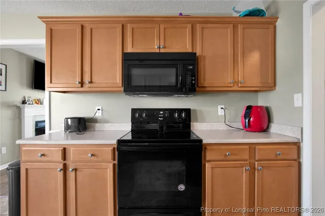 a kitchen with stainless steel appliances granite countertop a stove microwave and sink