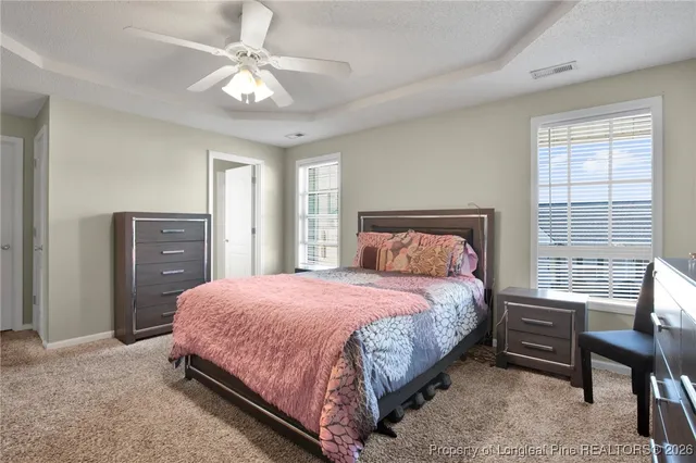 a bedroom with a bed and a table