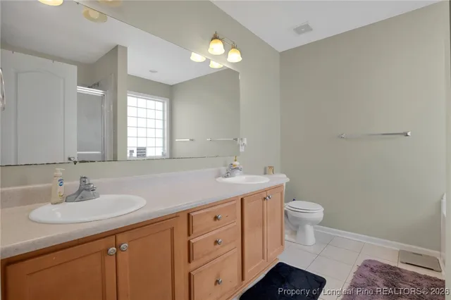 a bathroom with a sink toilet and a mirror