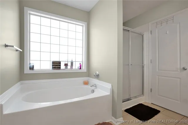 a bathroom with a bathtub and a window