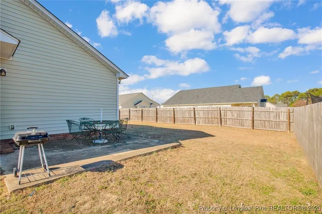a view of backyard with swimming pool and seating
