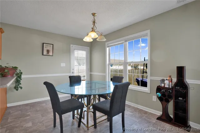 a dining room with furniture window and outside view
