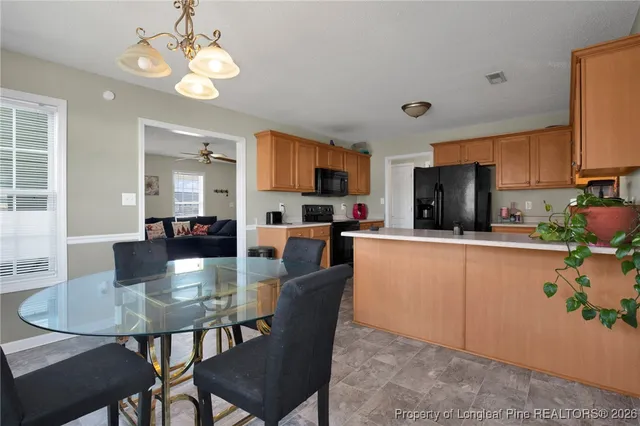 a kitchen with a dining table and chairs