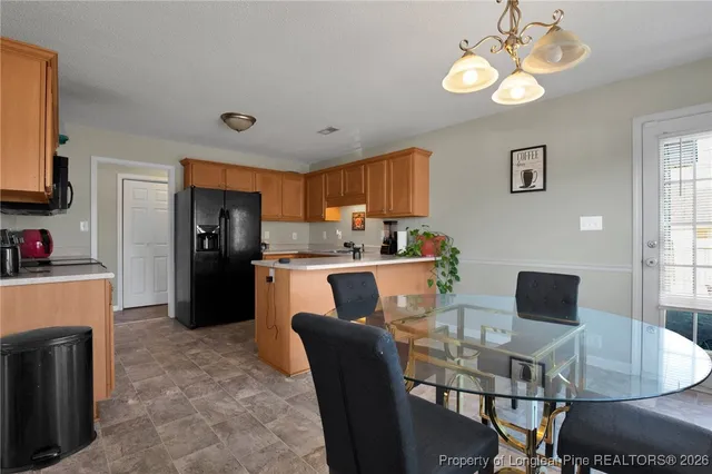 a dining room with furniture and a kitchen