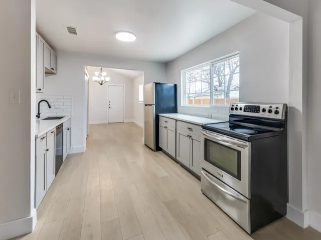 a kitchen with stainless steel appliances granite countertop a stove and a sink