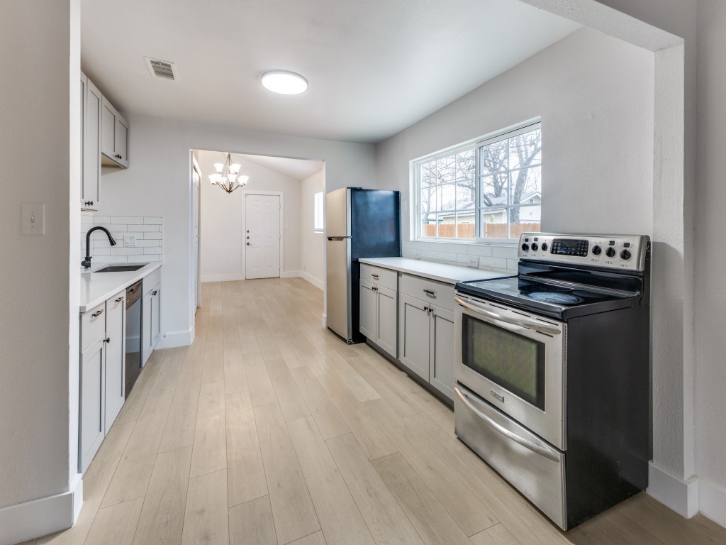 1108 Vasquez Street Austin, TX 78741 - Photo 17 of 33 a kitchen with stainless steel appliances granite countertop a stove and a sink