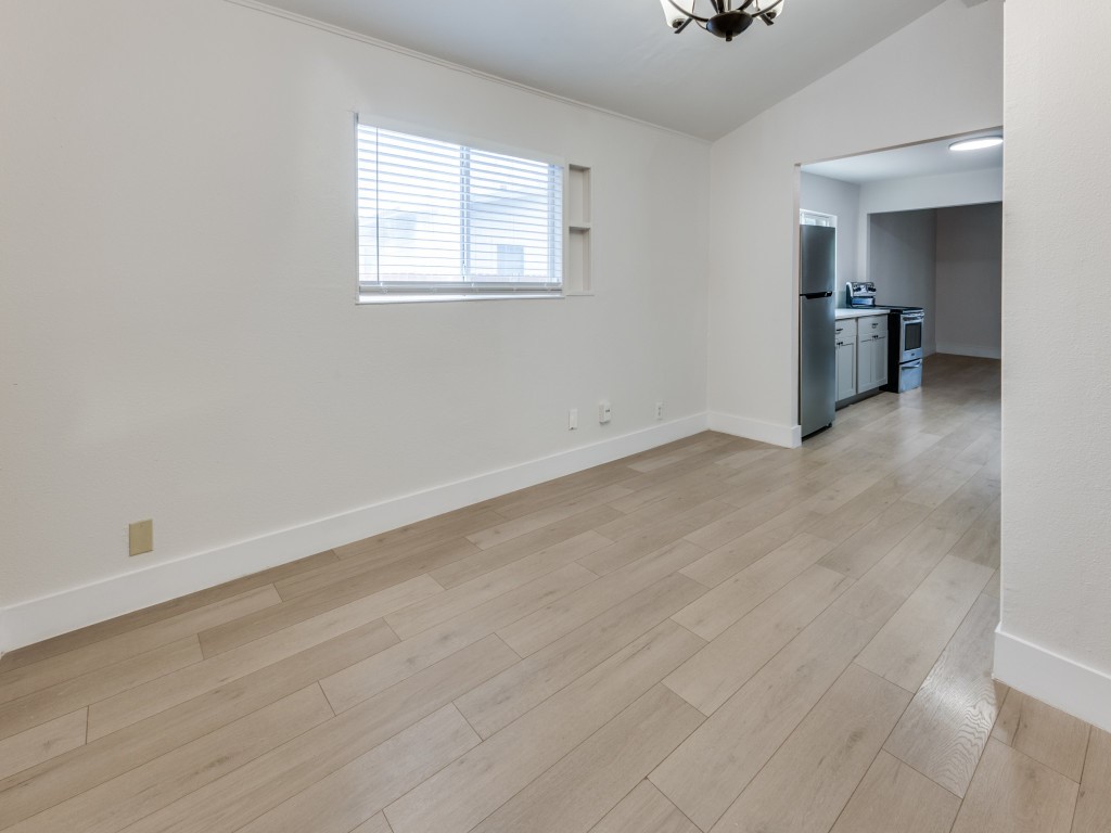1108 Vasquez Street Austin, TX 78741 - Photo 18 of 33 an empty room with a window and wooden floor