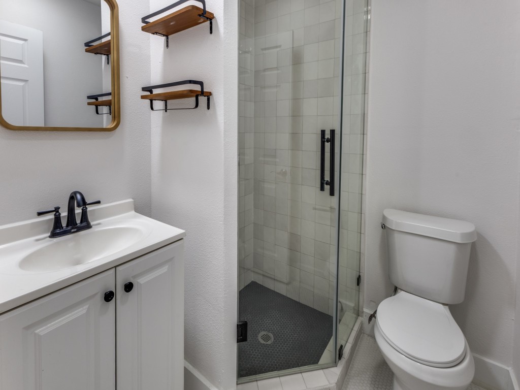 1108 Vasquez Street Austin, TX 78741 - Photo 21 of 33 a white toilet sitting next to a bathroom sink