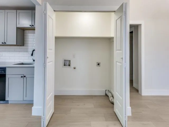 a view of a kitchen with white cabinets