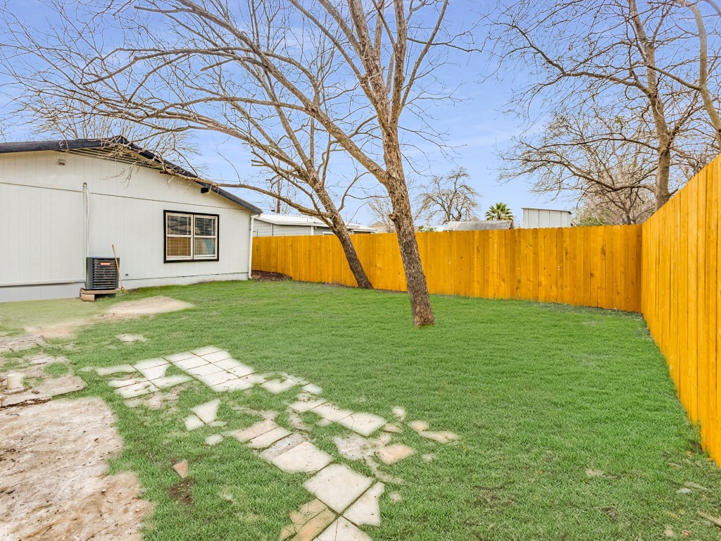 1108 Vasquez Street Austin, TX 78741 - Photo 31 of 34 View of yard featuring a fenced backyard and central AC unit