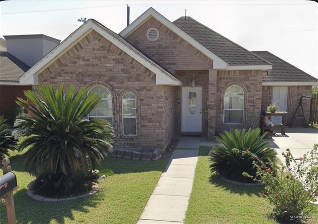 66 Santa Elena Lane Rio Grande City, TX 78582 - Photo 1 of 3 a view of a house with a small yard plants and a large tree
