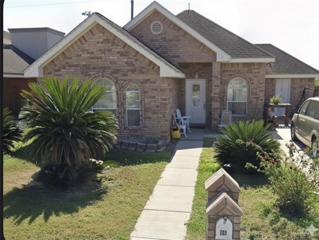 66 Santa Elena Lane Rio Grande City, TX 78582 - Photo 2 of 3 a front view of a house with a garden