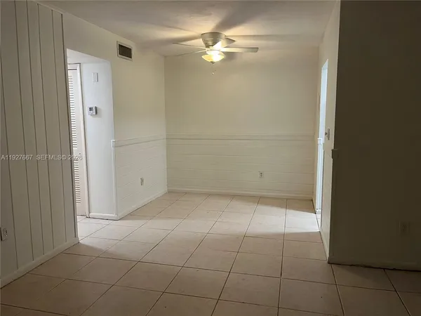 a view of an empty room with a fan