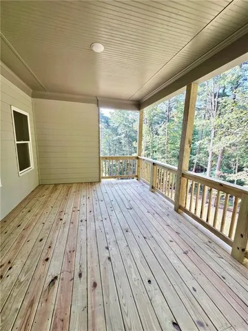 a view of outdoor space with wooden floor and balcony