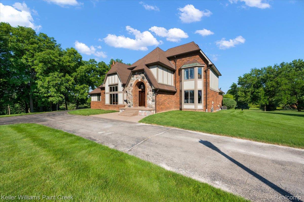69069 Campground Road Romeo, MI 48065 - Photo 4 of 78 Brick and stone facade residence featuring multiple gables and a prominent arched entryway