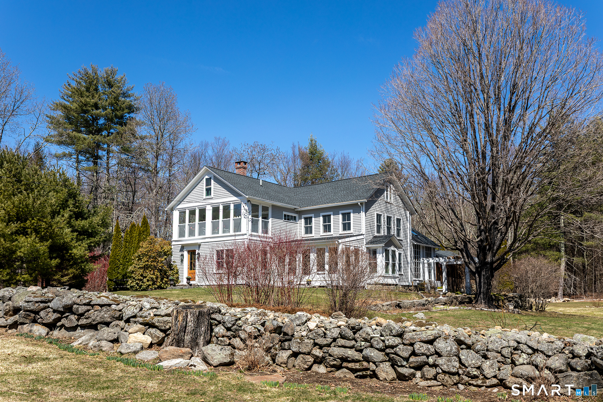 a front view of a house with a yard covered with snow