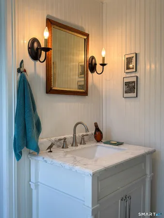 a white chair sitting next to a white bed