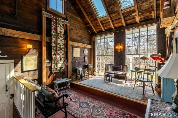 a living room with furniture a flat screen tv and windows