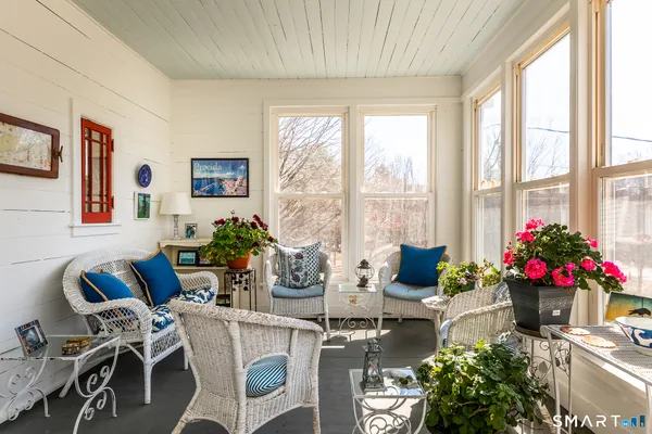 a living room with furniture and a potted plant