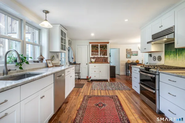 a kitchen with sink and a large window