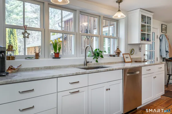 a kitchen with a stove a sink and a refrigerator