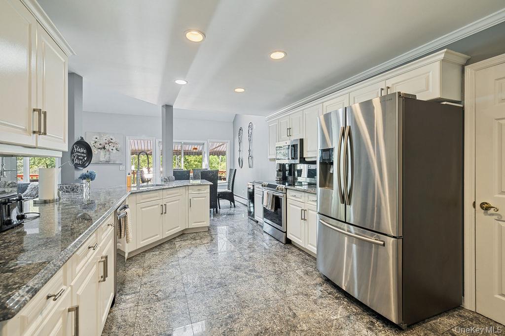 14 Blue Note Drive Stony Point, NY 10980 - Photo 13 of 48 a kitchen with refrigerator and cabinets