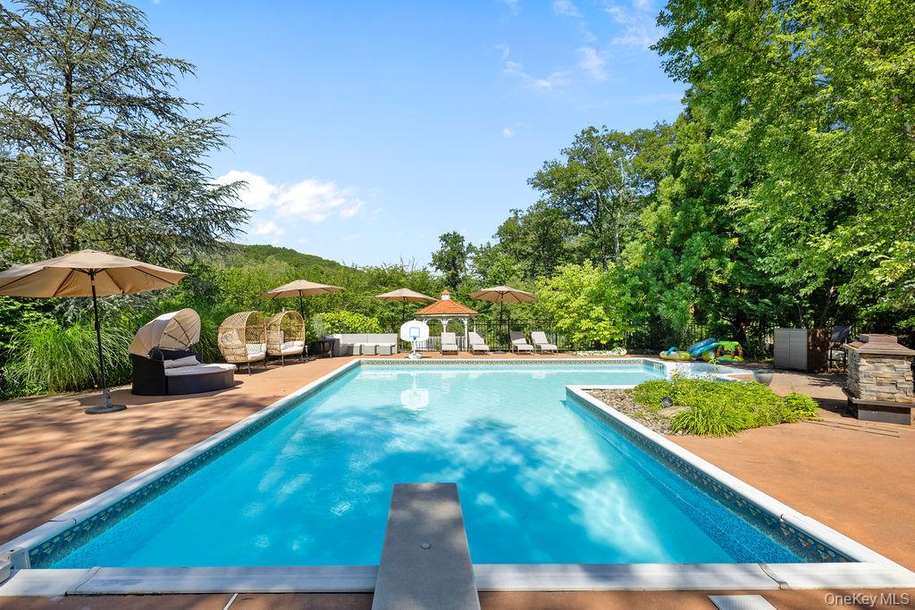 14 Blue Note Drive Stony Point, NY 10980 - Photo 39 of 48 a view of a pool with lawn chairs under an umbrella