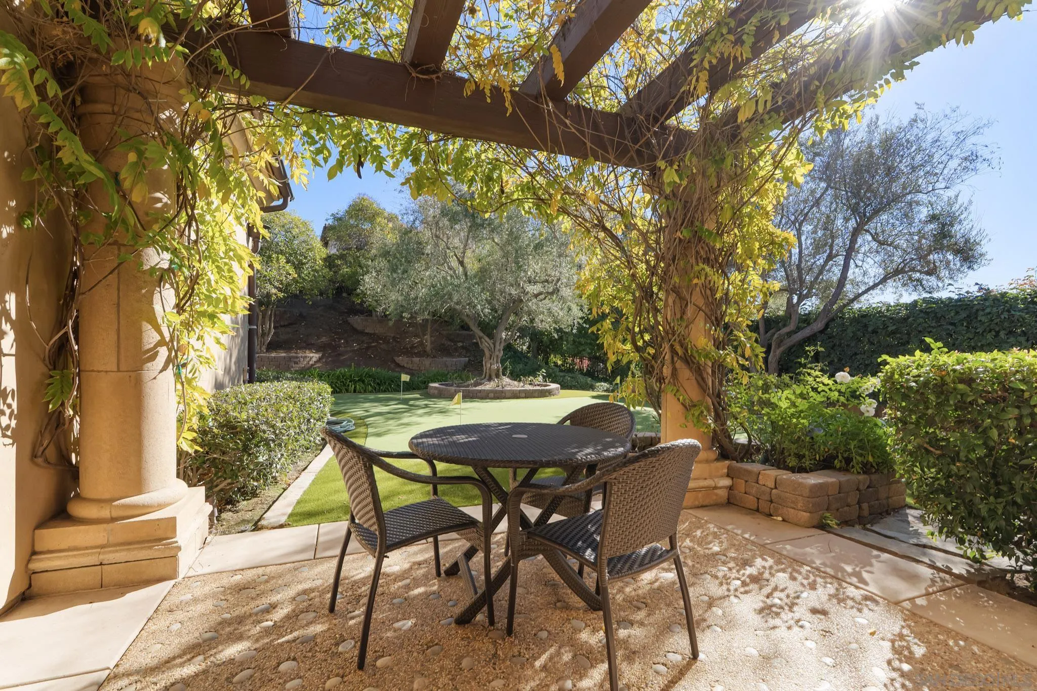 18486 Via Candela Rancho Santa Fe, CA 92091 - Photo 23 of 34 a patio with table and chairs and potted plants