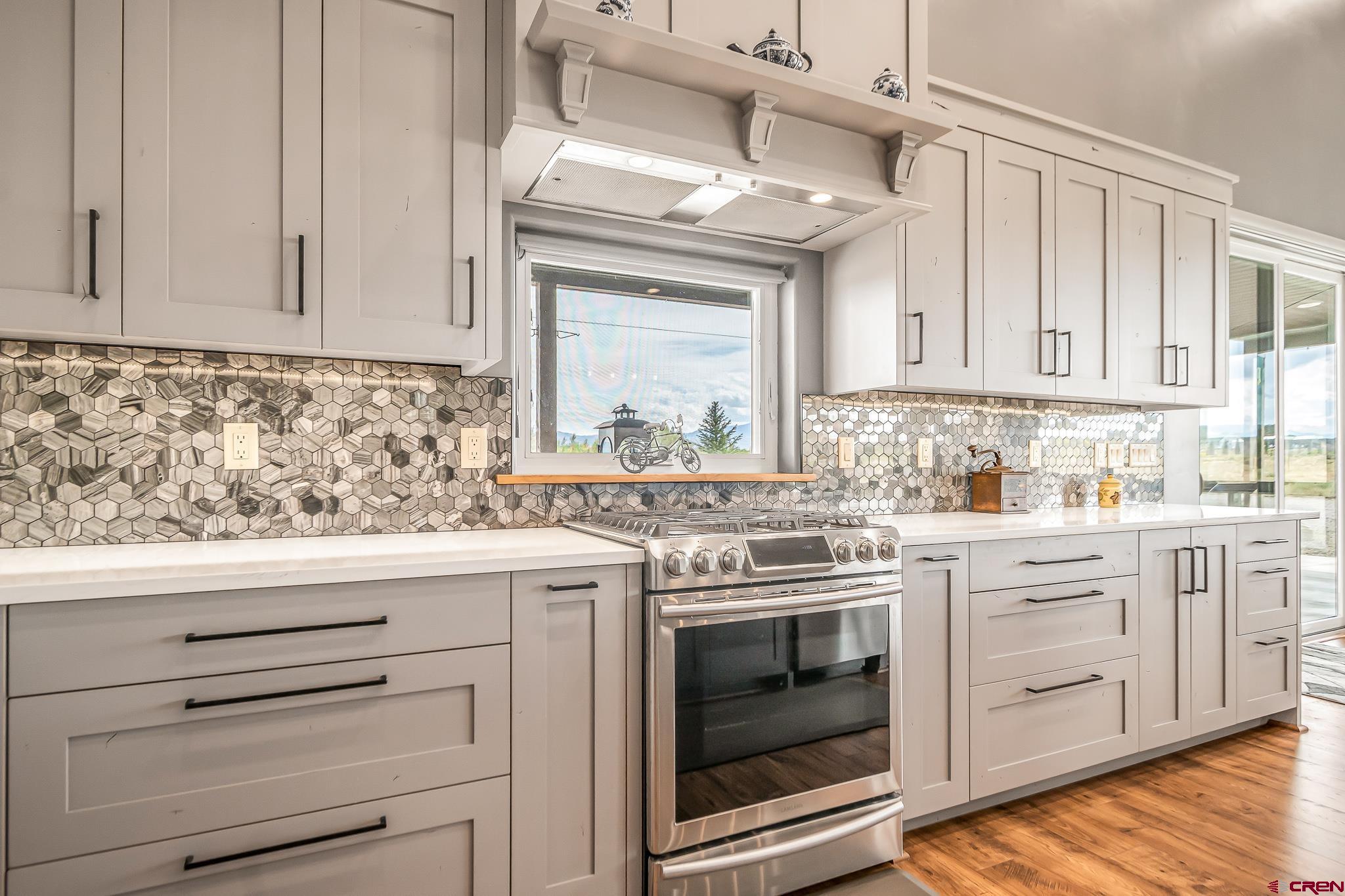 18236 6300th Road Montrose, CO 81403 - Photo 9 of 35 Open and spacious, custom 'soft close' cabinetry, quartz counter tops, kitchen island
