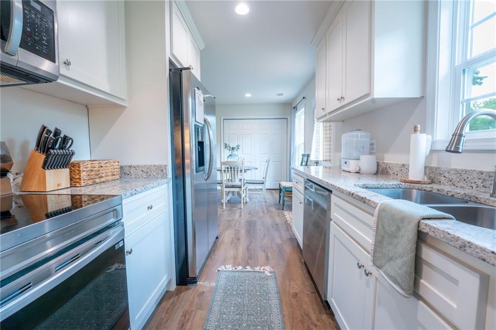 118 Wash Rider Road Dahlonega, GA 30533 - Photo 20 of 37 a kitchen with granite countertop lots of counter top space and wooden floor