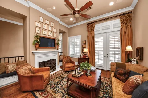 a living room with furniture a fireplace and a flat screen tv